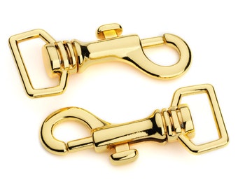 May include: Two gold-toned metal clasps with a swivel hook and a D-ring. The clasps are commonly used for attaching leashes, straps, or other accessories.