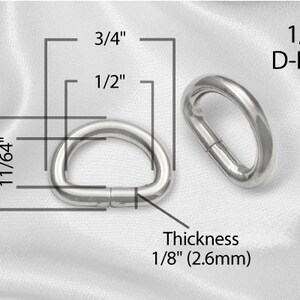May include: A silver D-ring with a 1/2 inch diameter and 1/8 inch thickness. The ring is 3/4 inch long and 11/64 inch wide.