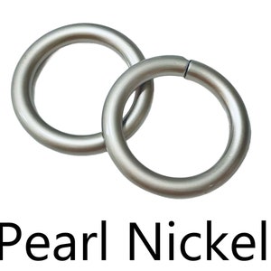 May include: Two silver metal rings, linked together. The rings are smooth and have a pearl nickel finish.
