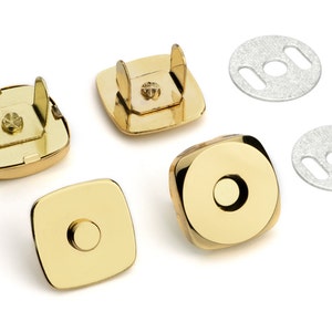 May include: Four gold-toned magnetic closures for bags or purses. Two closures have a square shape with a small hole in the center. Two closures have a round shape with a larger hole in the center. Two silver metal plates with two slits each are also included.