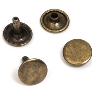 May include: Four antique gold metal rivets, two with a raised center and two flat, for use in leather craft or other DIY projects.