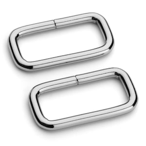 May include: Two silver metal rectangular D-rings. The rings are smooth and shiny.