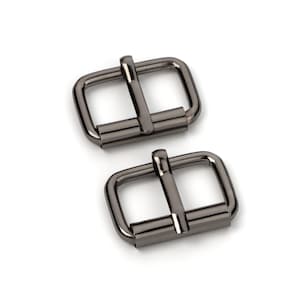 May include: Two black metal buckle closures. The buckles are rectangular with a smooth, shiny finish.