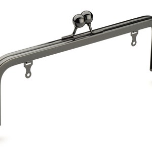 May include: A black metal purse frame with two round knobs at the top.