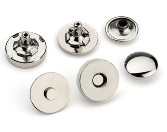 May include: A set of six silver magnetic snap closures for sewing projects. The snaps are round and have a smooth, shiny finish.
