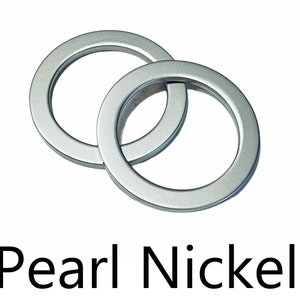 May include: Two interlocking silver rings with a smooth, shiny finish. The rings are labeled "Pearl Nickel".