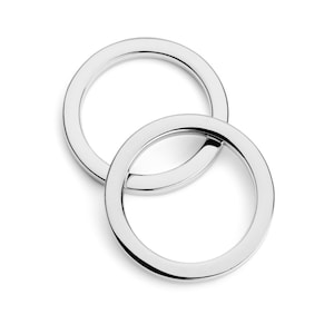 May include: Two silver metal key rings, one slightly larger than the other, are interlocked.