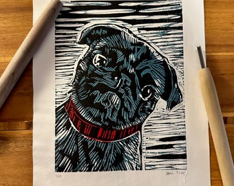 May include: A black and white linocut print of a pug dog with a red collar. The dog is looking to the left and has a curious expression. The print is signed "Loni 9149" in the bottom right corner.