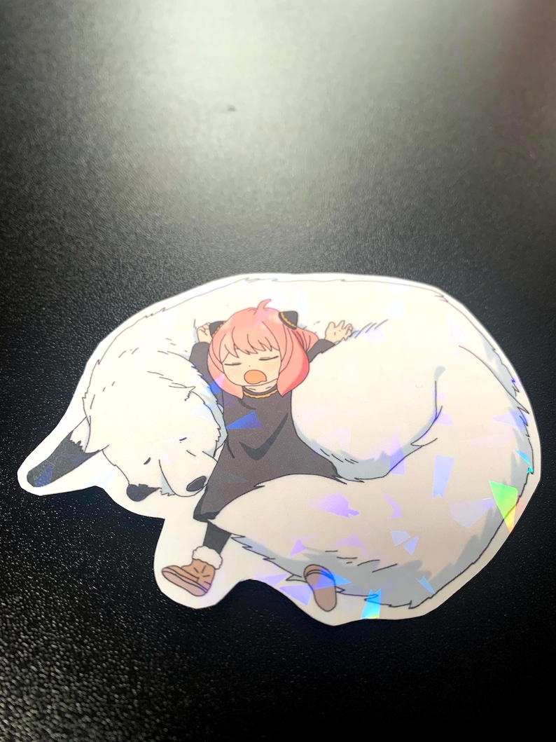 May include: A sticker featuring a cartoon girl with pink hair sleeping on a white furry animal with a holographic finish.