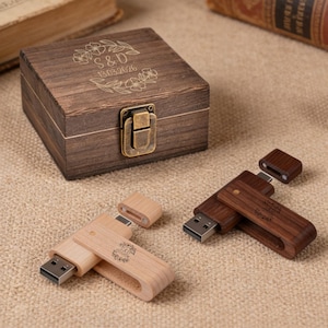 May include: Wooden USB flash drives and a small wooden box with a clasp. The box is engraved with the initials "S&D" and the date "13.03.2026". The USB drives are made of light and dark wood.