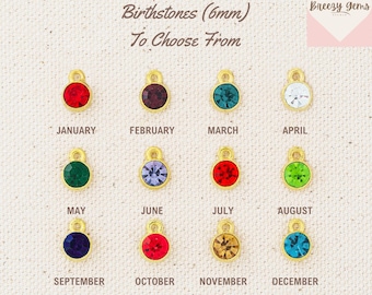 May include: A chart showing 12 birthstones, each in a gold setting with a 6mm stone. The stones are arranged in rows by month, starting with January and ending with December. The chart is labeled "Birthstones (6mm) To Choose From".