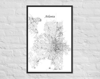 May include: A framed black and white map of Atlanta, Georgia. The map shows the city's road network and is labeled "Atlanta" in a simple font. The map is set against a white background and framed in a black border.