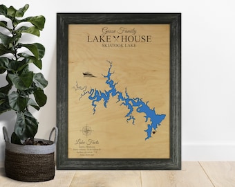 May include: A wooden sign with a map of Skiatook Lake, Oklahoma. The sign is framed in black and has the text "Gnose Family Lake House Skiatook Lake" at the top. The sign also includes a compass and some lake facts.