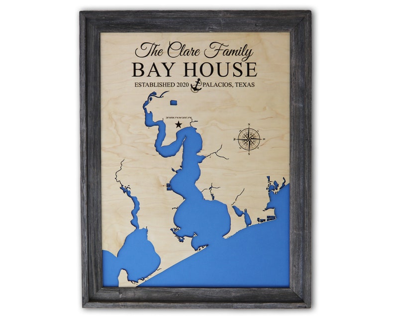 a wooden map of bay house with a black frame