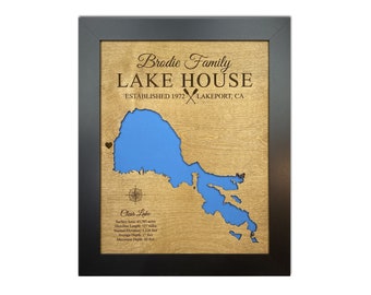 May include: A wooden plaque with a blue lake map, the text "Brodie Family Lake House Established 1972 Lakeport, CA" and details about Clear Lake, including surface area, shoreline length, normal elevation, average depth, and maximum depth.
