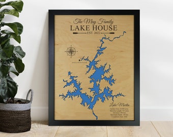 May include: A wooden sign with a blue lake map cutout, titled "The May Family Lake House Est. 2022". The map shows the outline of Lake Martin with details about its surface area, shoreline length, elevation, maximum depth, and completion year.