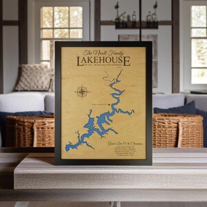 May include: A framed wooden map of Grand Lake of the Cherokees with the text "The Nicoll Family Lakehouse Est. 2017 Grand Lake of the Cherokees" at the top. The map is in a black frame and has a compass rose in the upper left corner.