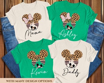 May include: Four white t-shirts with a leopard print Mickey Mouse design. The shirts have the names "Mama", "Ashley", "Kevin", and "Daddy" printed on them.