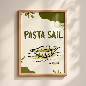 May include: A framed art print with a light wood frame. The artwork features the words "PASTA SAIL" in green, above a drawing of a pasta dish. Olive branches and green shapes decorate the off-white background.