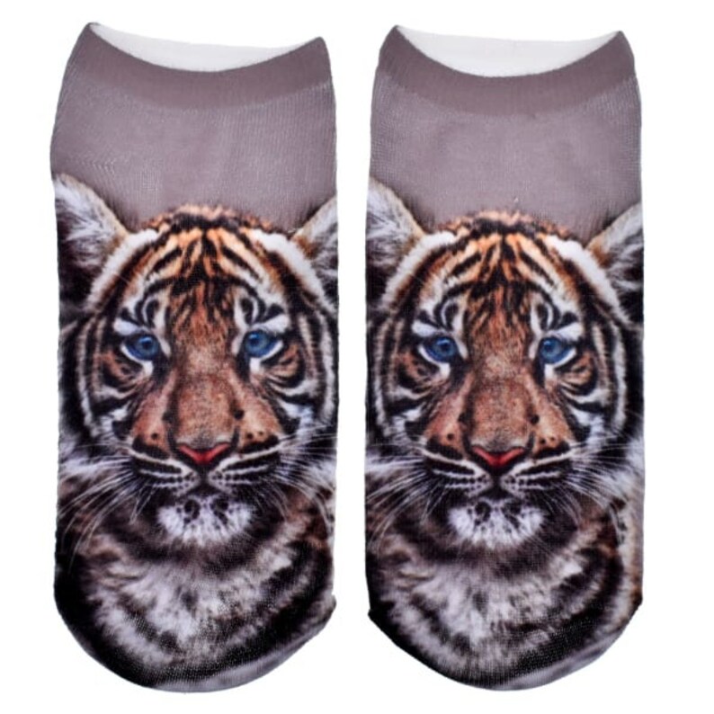 May include: A pair of ankle socks with a tiger face print. The tiger has blue eyes and brown and black stripes. The socks are gray.