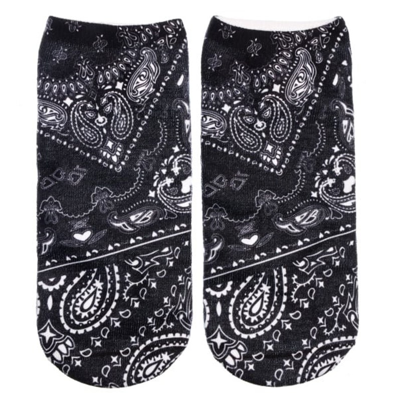 May include: A pair of black ankle socks with a white paisley pattern. The socks are made of a soft, comfortable material and are perfect for everyday wear.