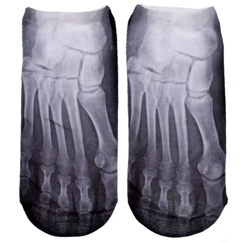 May include: A pair of black ankle socks with a graphic print of an x-ray image of a foot.