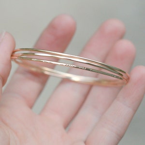 gold stacking bracelet. set of three bangles. 14k gold filled hammered wire bracelets. thin bangle. image 7