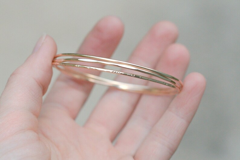 gold stacking bracelet. set of three bangles. 14k gold filled hammered wire bracelets. thin bangle. image 7