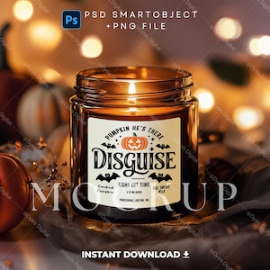 May include: A brown glass candle jar with a white label that says "Pumpkin He's There Disguise" with a cartoon pumpkin and bats. The label also says "Candied Pumpkin", "Light Lit Time 8 to 10 hours", and "Bae Smoke Wax".