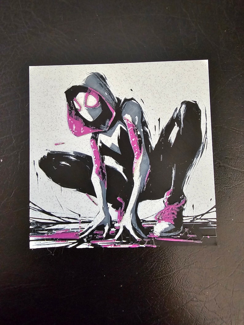 May include: A black and white illustration of a superhero in a pink and black costume, with a pink spider symbol on their chest. The superhero is in a crouching pose, with their arms outstretched and their legs bent. The background is a light grey colour.