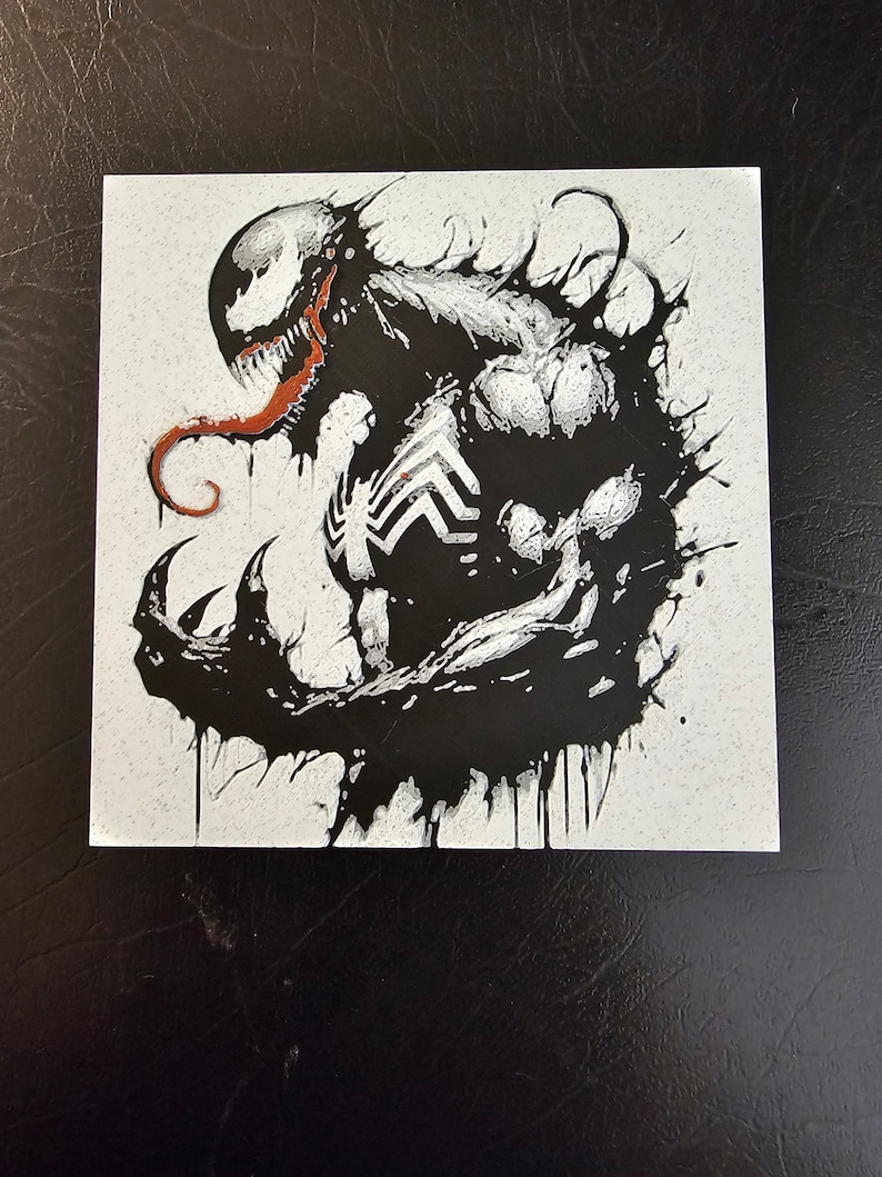 May include: Black and white illustration of Venom, a Marvel Comics superhero, with a red tongue. The image is on a white background.