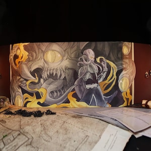 May include: A brown, tri-fold tabletop game screen featuring a fantasy illustration. The artwork depicts a robed figure facing a monstrous creature with flames and a large eye. The screen has brass clasps and is set on a table with maps and other game accessories.