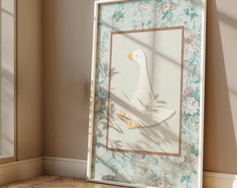 May include: A white goose with an orange beak is depicted in a framed illustration. The frame has a white border and a floral pattern in shades of blue, green, and pink.