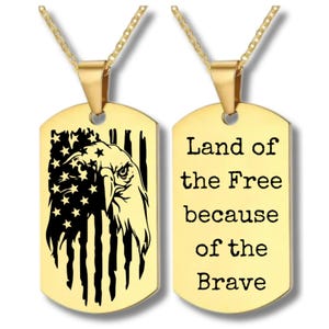 May include: Gold dog tag necklace with two pendants. One pendant features an American flag with an eagle and the other pendant says "Land of the Free because of the Brave".