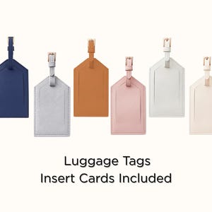 May include: A collection of luggage tags in various colors, including black, navy blue, gray, tan, pink, white, and green. Each tag has a rectangular shape with a top strap and a gold-colored buckle. The text "Luggage Tags Insert Cards Included" is at the bottom.