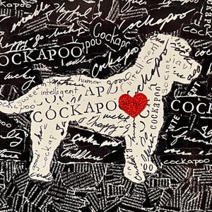 May include: A mixed media artwork featuring a white Cockapoo dog silhouette against a black background. The dog is filled with words like "sweet," "happy," and "cuddles." A red heart is placed on the dog's chest. The background is made of torn paper.
