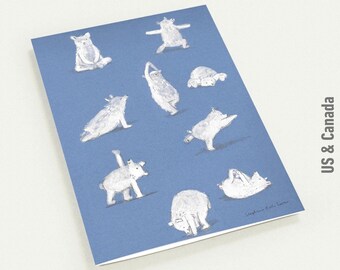 May include: A blue card featuring illustrations of various animals in yoga poses. The animals are white with gray shading. The text "US & Canada" is printed vertically on the right side of the card.