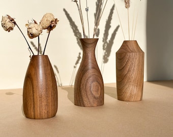 Small walnut vases for dried flowers in a rustic style for home decor.