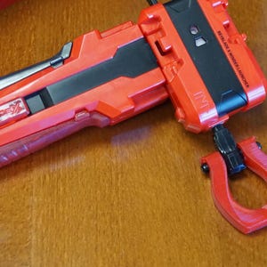 The Slip Grip in red attached to the black ripcord in the red launcher and red handle