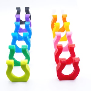 All color options of the Beyblade X Slip Grips from Momo's Models. The 12 color options include, Red, Cherry, Pink, Yellow, Orange, Lime, Green, Sky Blue, Blue, Purple, Black, and White