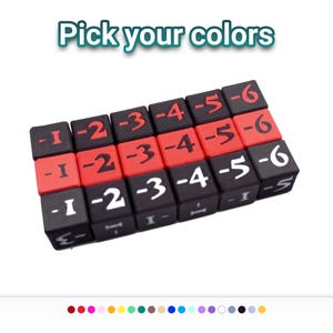May include: A set of eighteen square game dice arranged in three rows, featuring the text Pick your colors at the top. The dice are black and red with white, black, or red numbers ranging from negative one to negative six printed on each face.