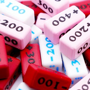A pile of the Attack Increase/Decrease 100-400 Markers in various colors.