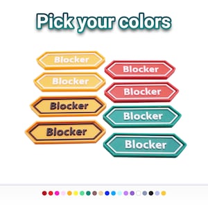 May include: A collection of eight hexagonal-shaped tags arranged in two columns, each featuring the word "Blocker" in raised lettering. The tags are displayed in yellow, orange, red, and teal color variations with contrasting text colors.