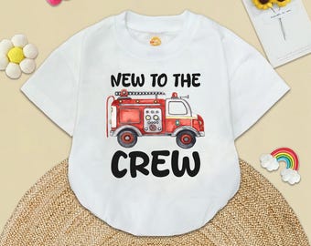 May include: White short-sleeved t-shirt with a red fire engine graphic and the text "New to the Crew".
