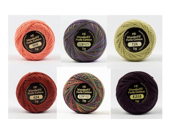 May include: Six spools of WonderFil Perle Cotton embroidery thread in various colors. The spools are labeled with the thread number and weight. The colors include orange, purple, green, red, multi-colored, and dark purple.