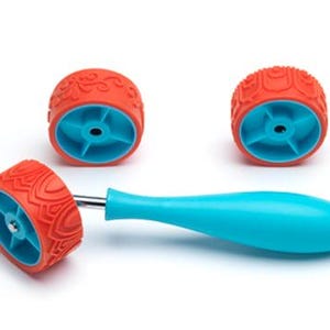 May include: Three orange rubber rollers with different patterns, one attached to a blue handle. The rollers are used for creating patterns on surfaces like clay or paint.