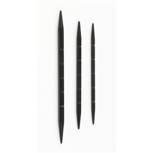 May include: Three black wooden double-pointed knitting needles of varying lengths are arranged vertically against a white background. Each needle has a pointed end and a series of horizontal grooves along its shaft, creating a textured appearance.