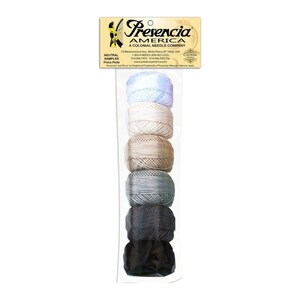 May include: A package of six spools of embroidery floss in neutral colors. The colors are light blue, white, beige, gray, dark gray, and black. The package is labeled "Presencia America, A Colonial Needle Company".