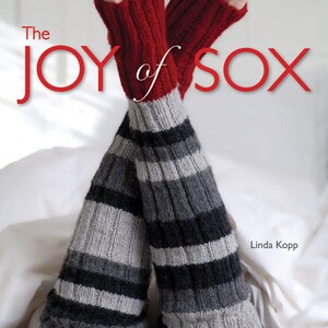 May include: The Joy of Sox book cover features a pair of legs wearing red and grey striped socks with the title "The Joy of Sox" in red letters. The text "30+ MUST-KNIT DESIGNS" is at the bottom of the cover and the author's name, "Linda Kopp", is in the bottom right corner.