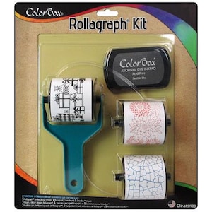 May include: A Rollagraph Kit with three different roller stamps and an inkpad. The roller stamps feature designs of presents, flowers, and a cracked pattern. The inkpad is black and says "Color Box Archival Dye Inkpad Acid Free Seattle Sky".